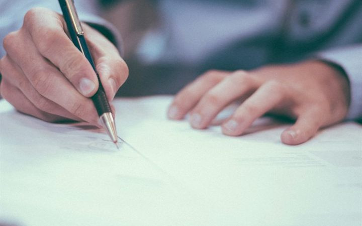 Person signing a legal document
